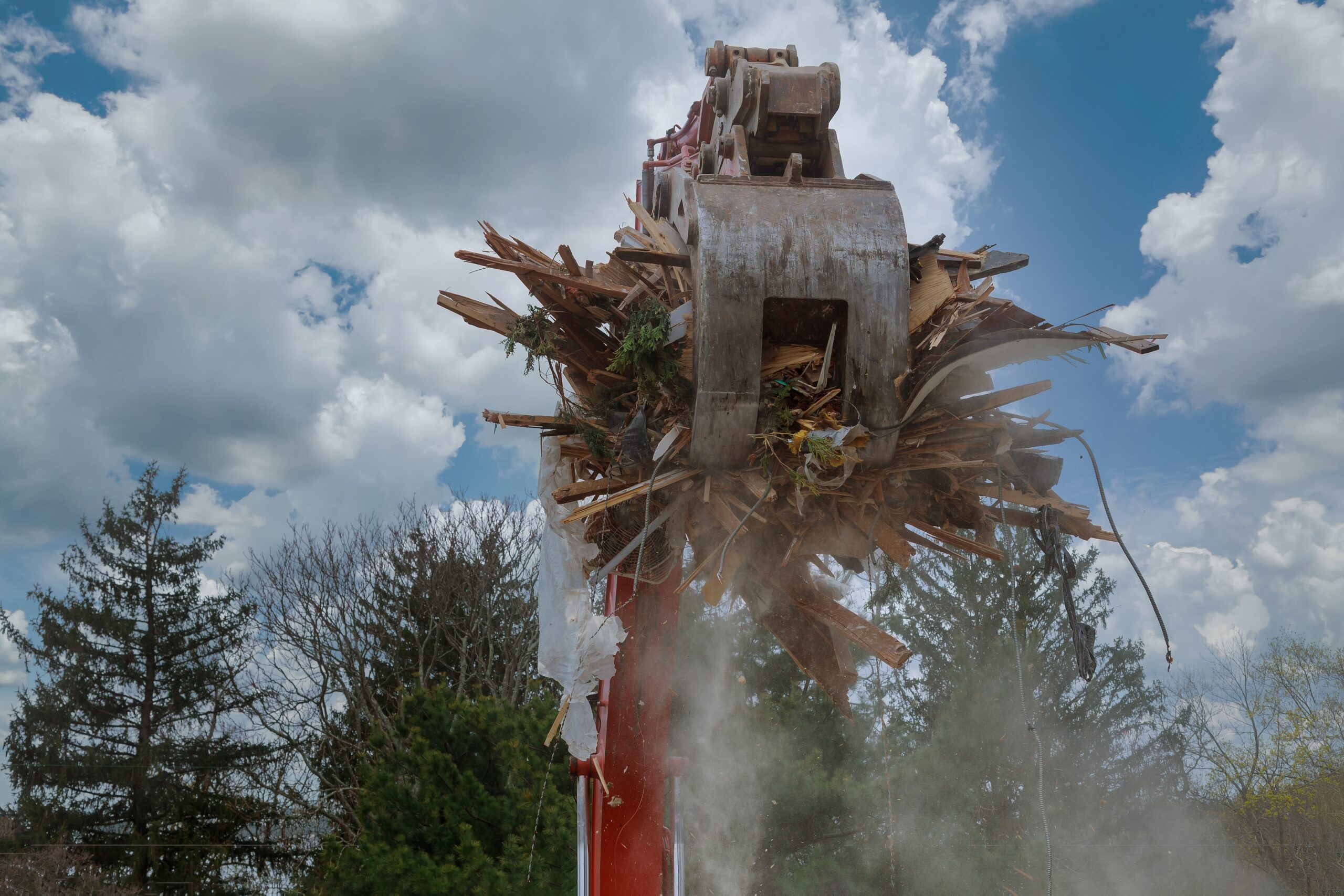 Demolition after a After a Fire, Dismantling an old house, bulldozer destroys of the demolition of a building under construction of a new house.